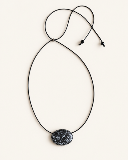Super long snowflake obsidian pendant necklace with natural black and white speckled stone on adjustable black wax rope cord
