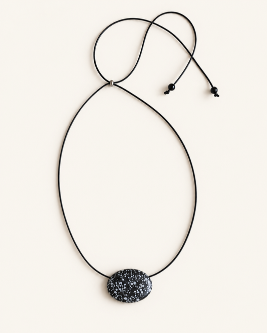 Super long snowflake obsidian pendant necklace with natural black and white speckled stone on adjustable black wax rope cord