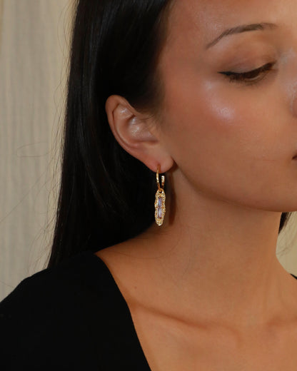 Twilight Gleam gold drop earrings with baguette-cut purple zircon stones, hammered organic pendants and polished gold hoops model