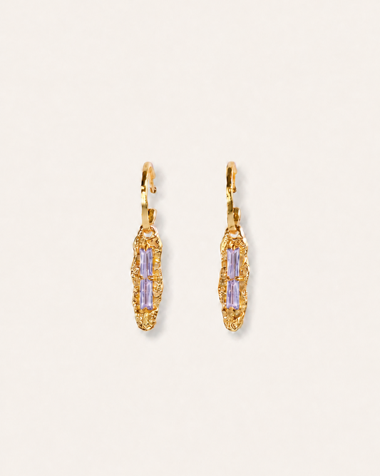 Twilight Gleam gold drop earrings with baguette-cut purple zircon stones, hammered organic pendants and polished gold hoops.