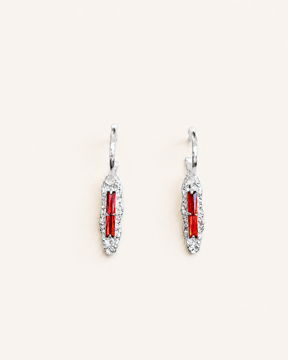 Vintage red cubic zirconia long drop earrings with a high-polish silver finish and textured elongated pendants.