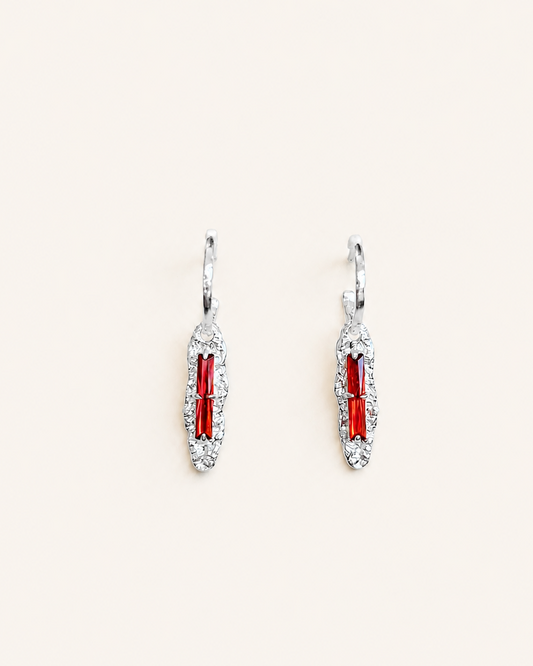 Vintage red cubic zirconia long drop earrings with a high-polish silver finish and textured elongated pendants.