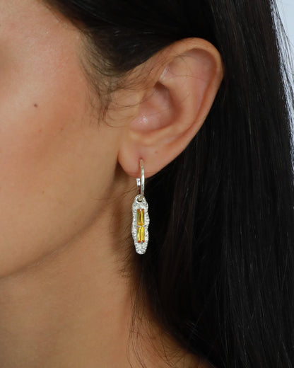 Close-up of yellow zircon drop earrings worn, highlighting closed-back bezel design

