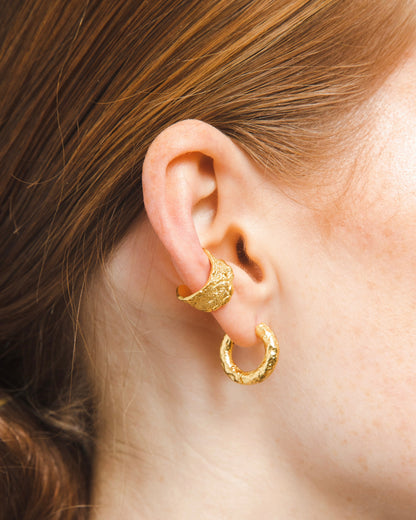 gold adjustable textured ear cuffs for non-pierced ears, nickel-free with an organic sculptural finish on model ear